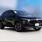 Black Chevrolet SUV photographed in a studio with a blue blurred background, showing its front and side.**